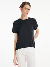 A lady wears a silk T-shirt.